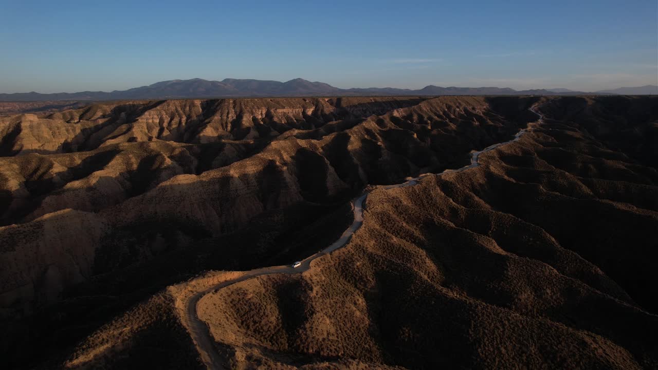 Van parked on a road in the middle of a hill. Gorafe desert in Granada, Spain