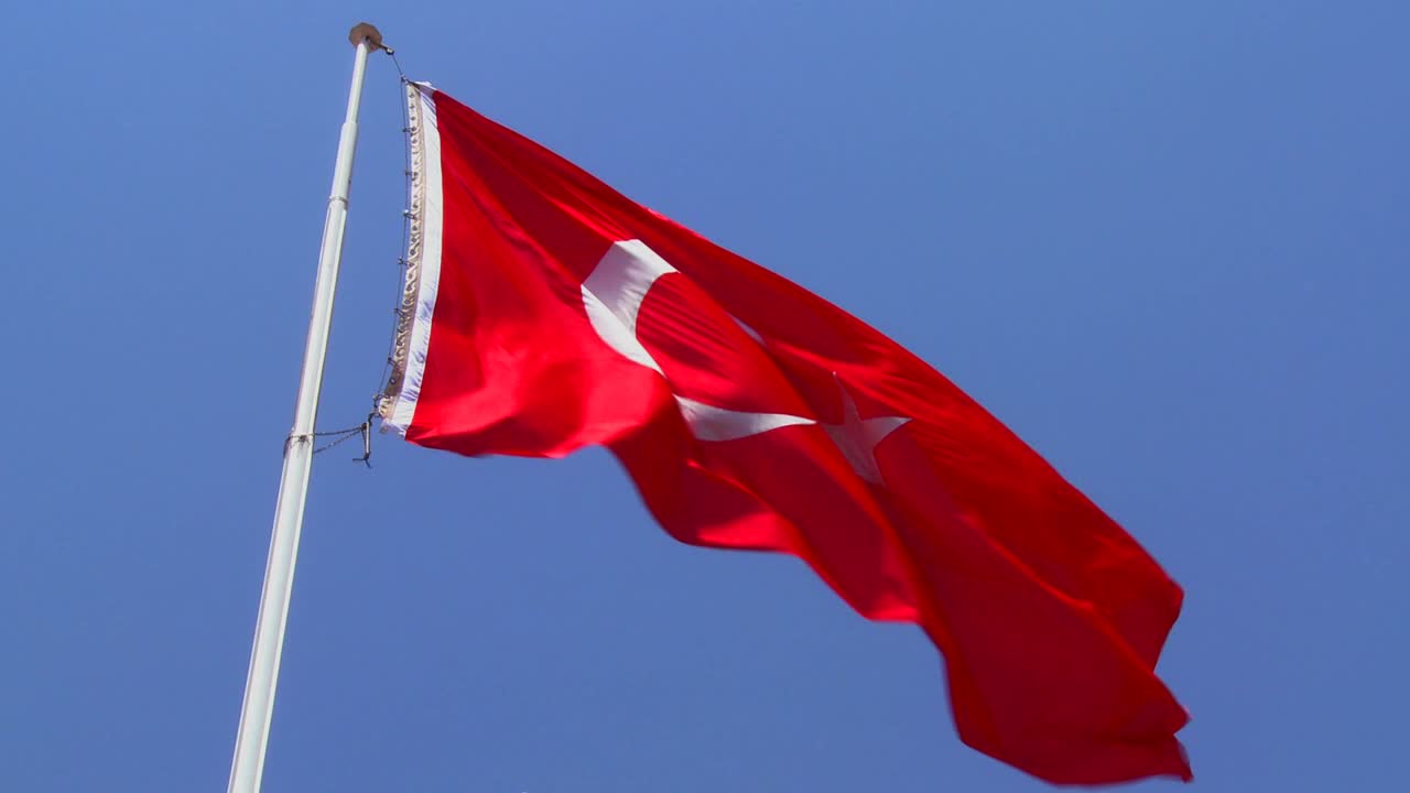 A Turkish flag flies near a mosque 1