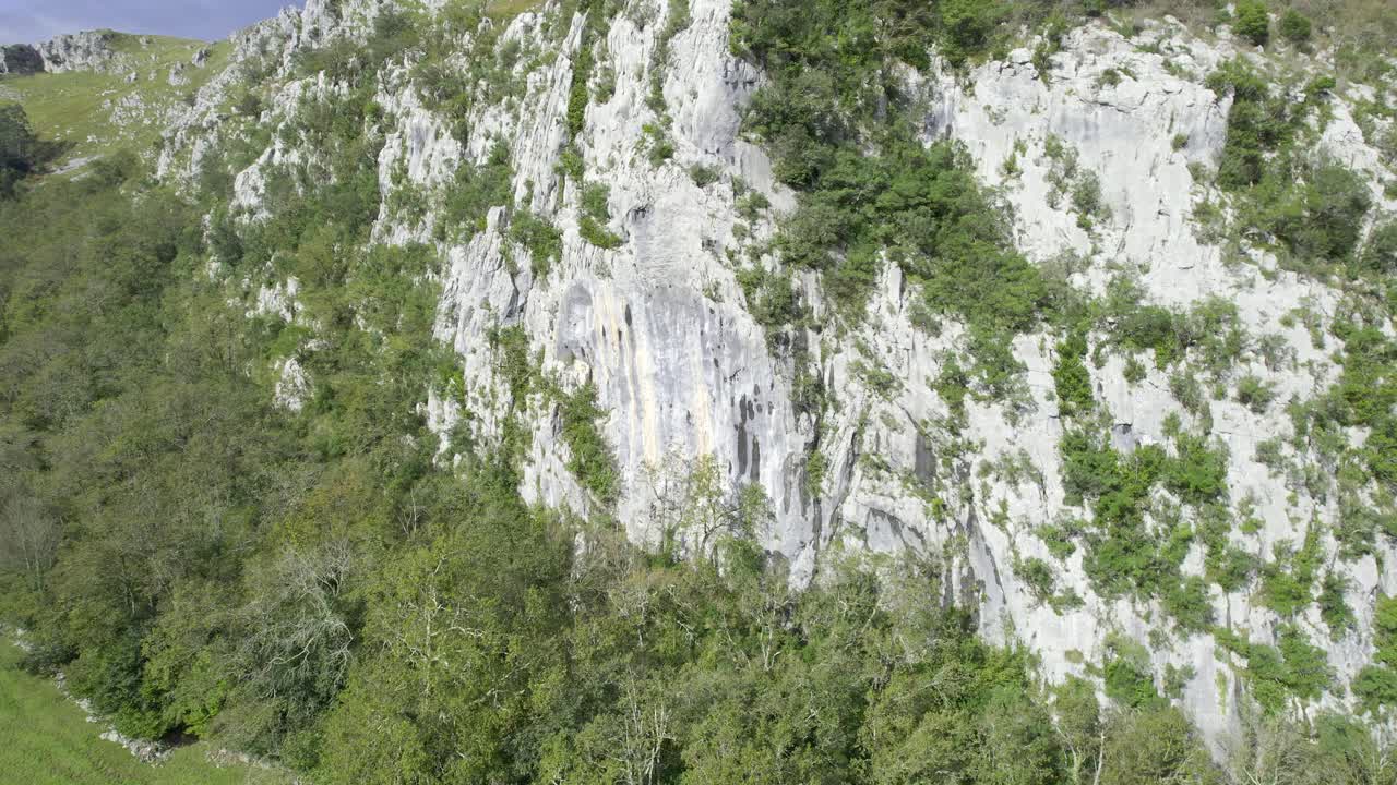drone approaching climbing wall in a rural environment in the north of Spain. 4k aerial video.