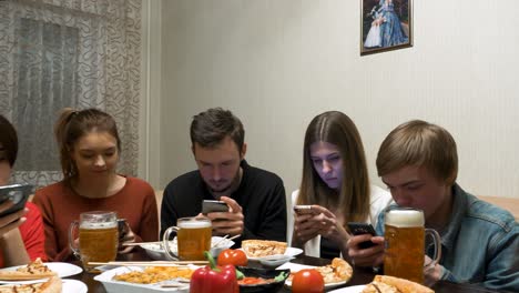 friends enjoying dinner and social media