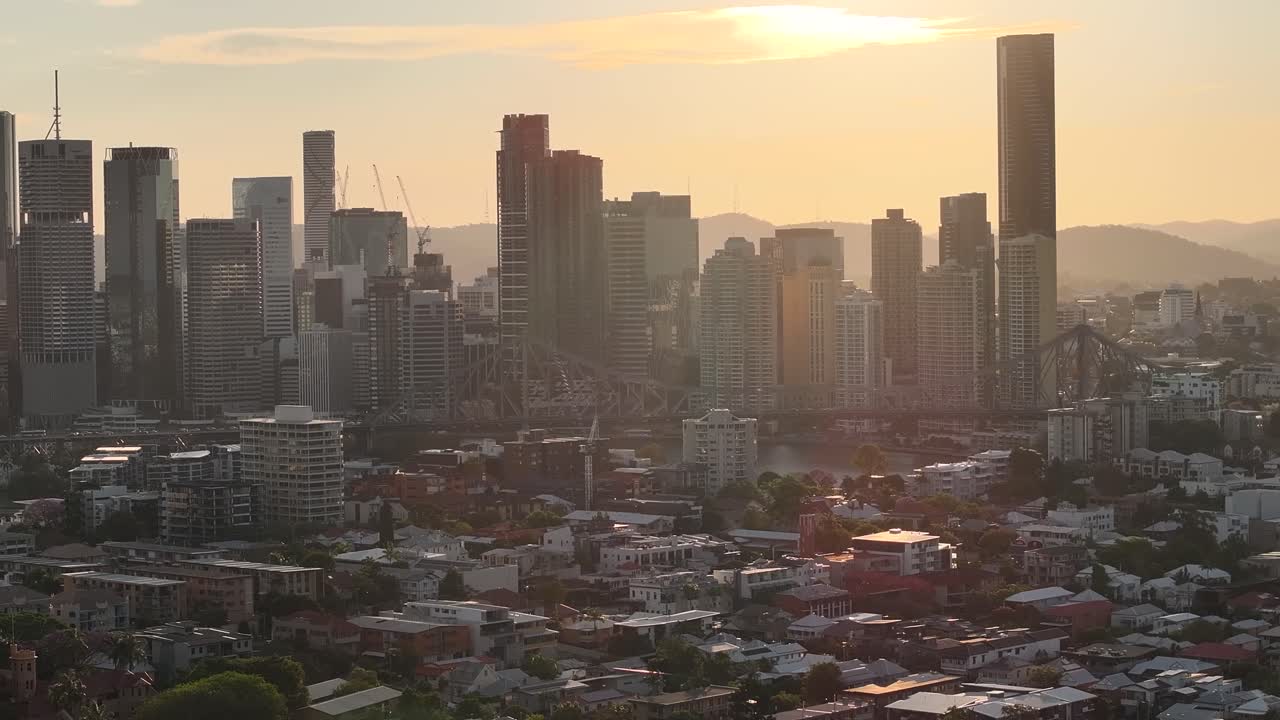 Amazing sunset warm skyline and skyscrapers in Brisbane downtown. Aerial cityscape.