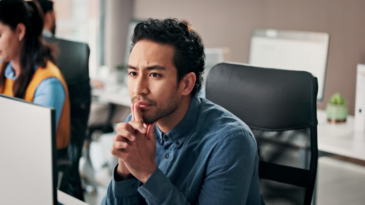 Thoughtful Businessman Concentrating While Working in a Modern Office