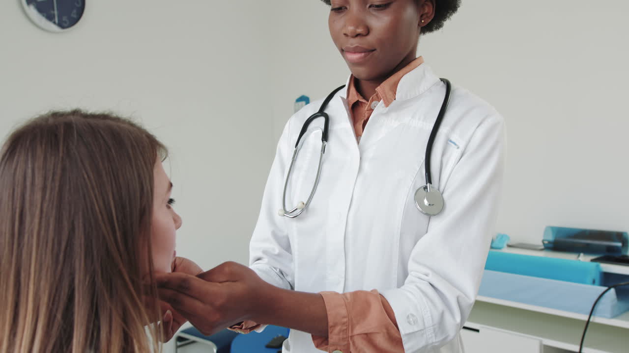 Endocrinologist examining patients thyroid gland iodine deficiency symptom female doctor checking