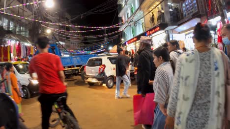 hyperlapse of people walking in the busy city center by night - kathmandu, nepal