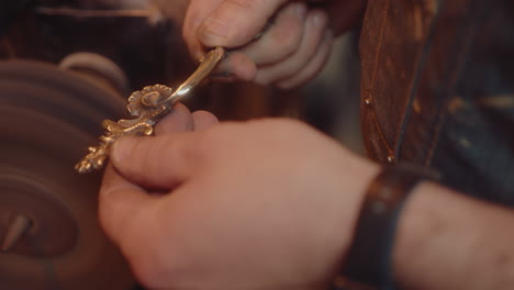 polishing vintage furniture handle with buffing machine