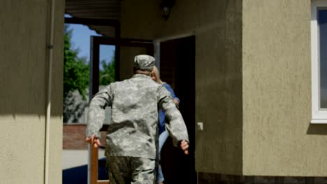 loving wife meeting soldier at home