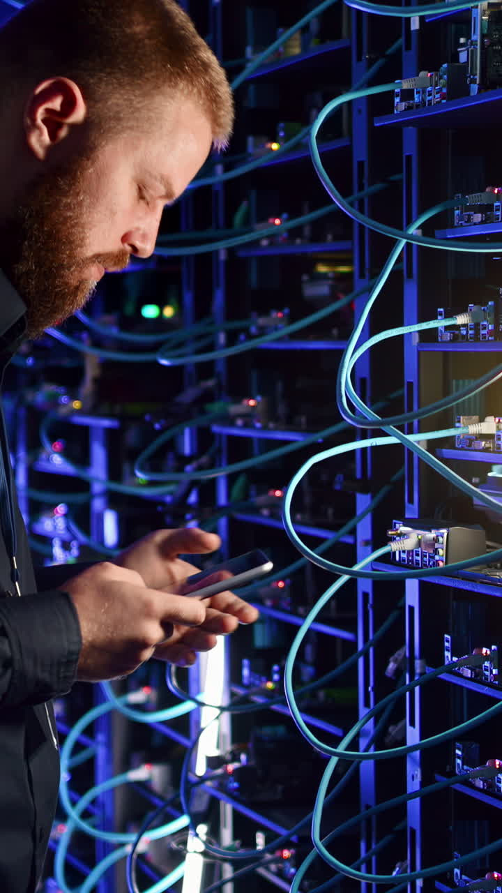 Man analysing data in a server room. Vertical