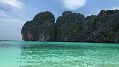 Maya-Bay-in-Phi-Phi-Islands-National-Park,-wave,-sand-beach,-and-beautiful-crystal-clear-water-at-a-popular-tourist-destination-in-Krabi,-Southern-of-Thailand