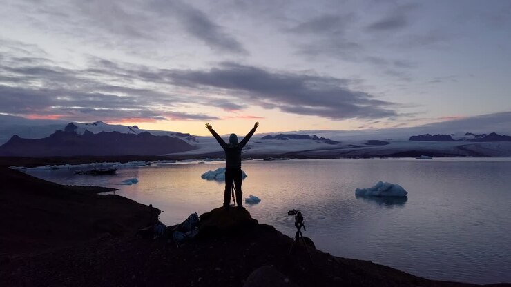 Silhouette of a Person at Sunset on an Icelandic Glacier Lake