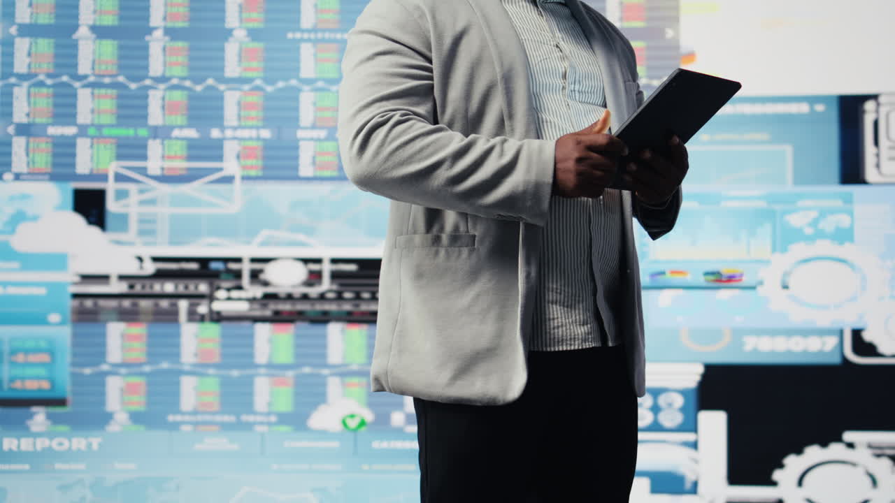 Black male entrepreneur reviews financial graphs and KPI models