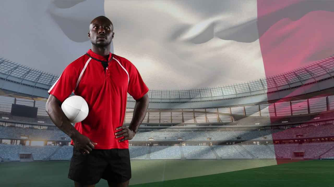 Jogador de rugby profissional de pé em frente a uma bandeira e um estádio
