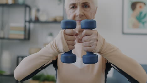 senior woman exercising at home with dumbbells