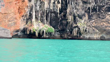 tour boat cruising past krabi's stunning cliffs