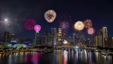 nighttime cityscape illuminating with explosive, colorful fireworks reflecting dramatically across water surface, creating mesmerizing festive atmosphere celebrating special moment