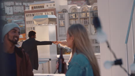 happy young multiracial couple dancing on rooftop at sunset celebrating relationship having fun enjoying playful dance party together