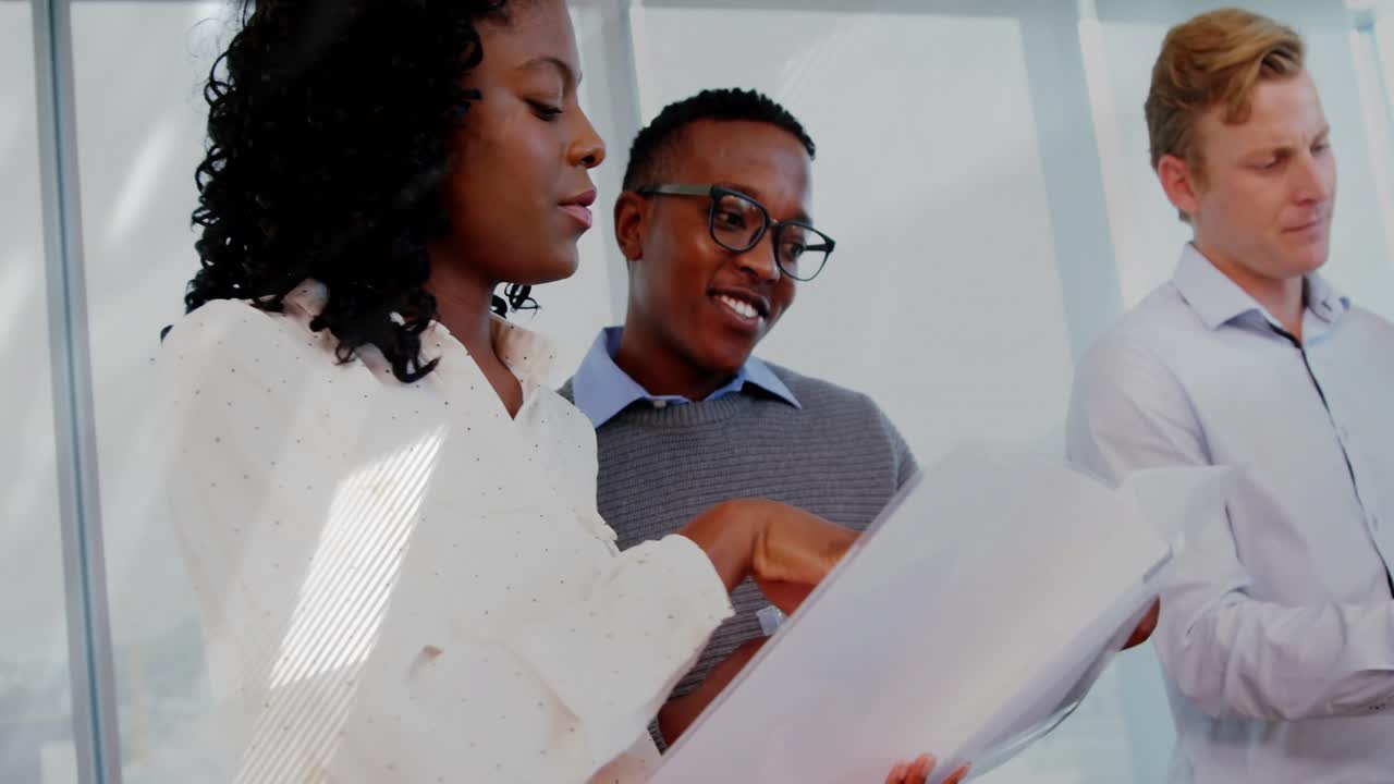 Business manager pointing chart sparking team reviewing data, man unveiling tablet showing graphs