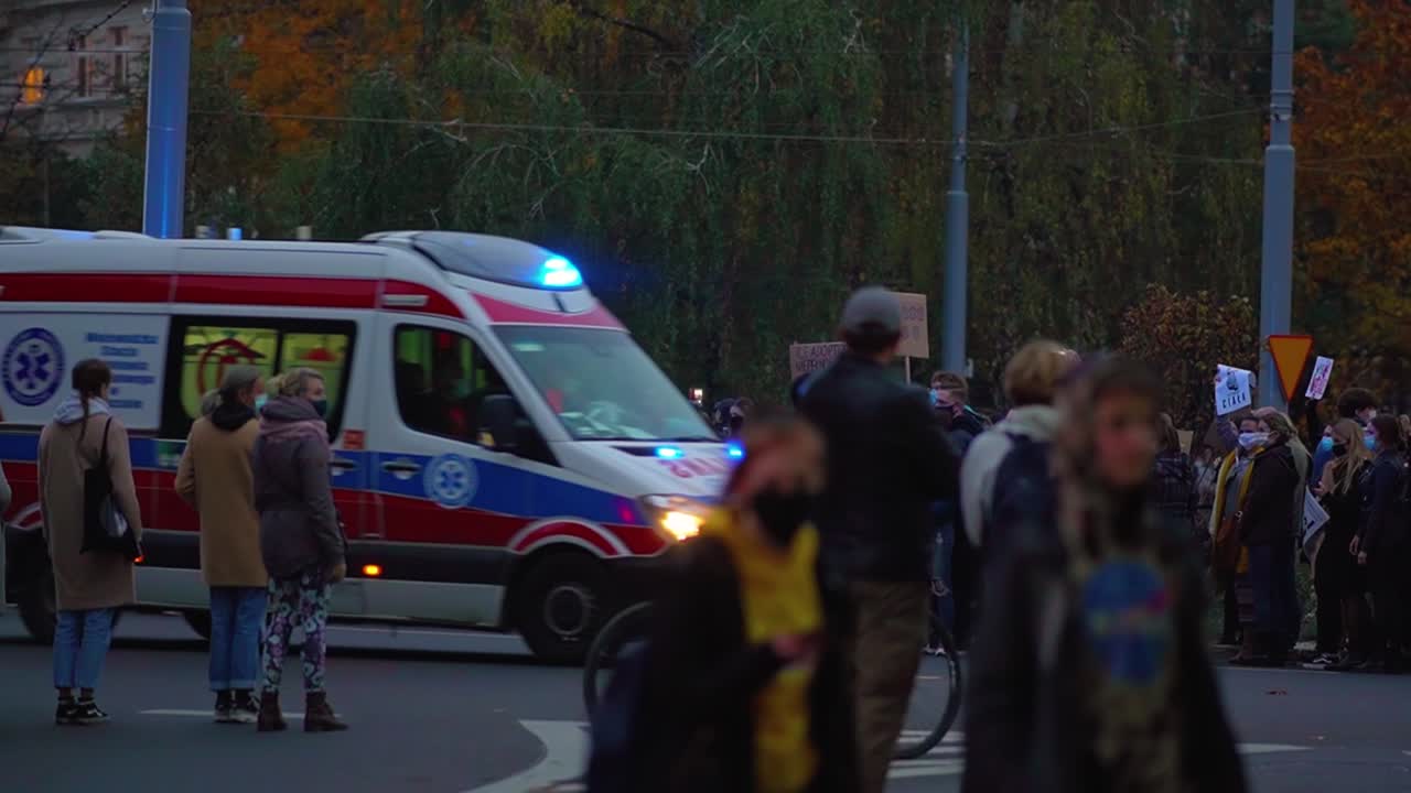 People Protesting Against Abortion Ban On The Street Of Szczecin In Poland. Ambulance Passes By On The Road - wide shot, slow motion