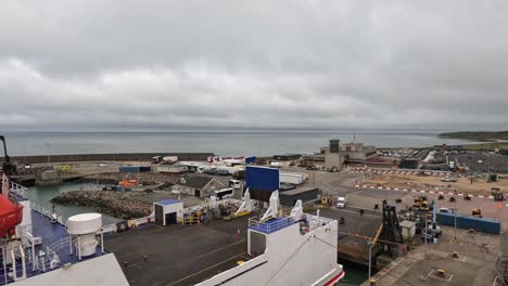 motorcyclists disembark from large transport ferry under overcast sky