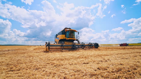 yellow combine harvester working on the field. modern combine during seasonal workers in the farmland. agricultural machine on the field under blue sky.
