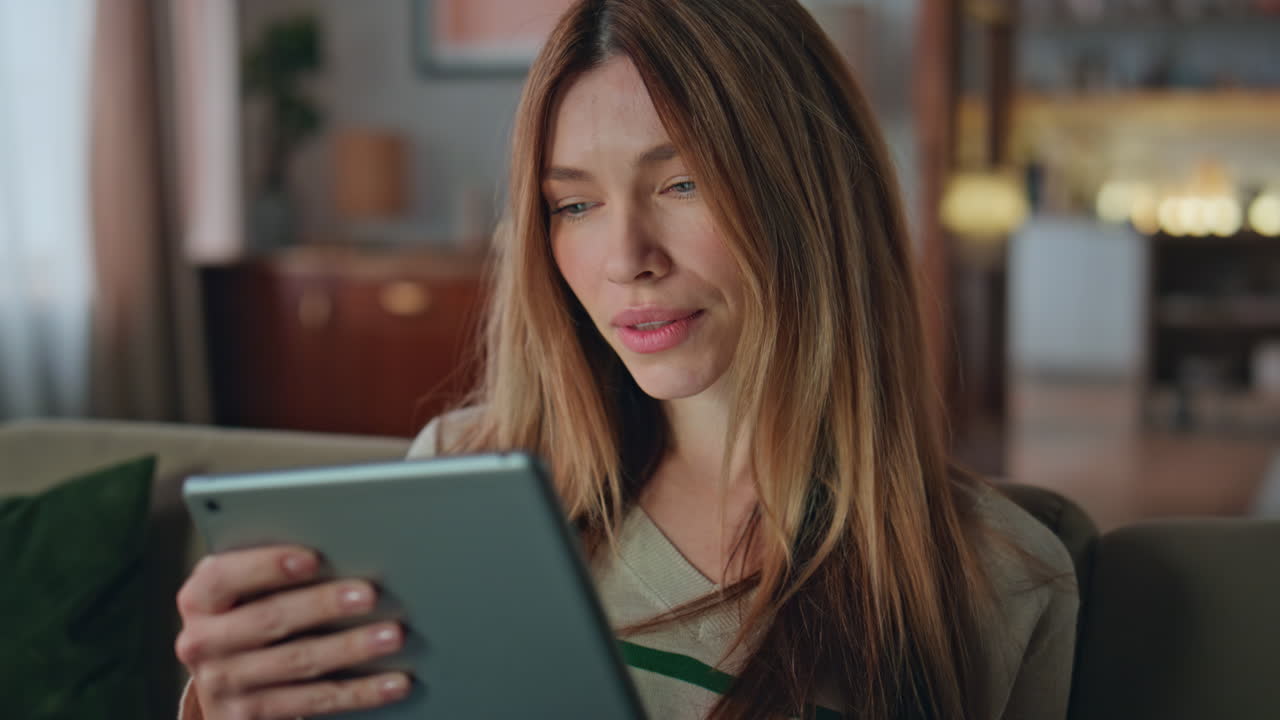 Freelancer surfing internet tablet at apartment close up. Portrait woman online