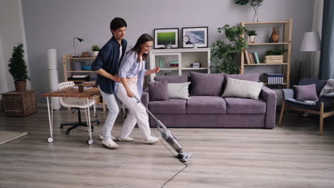 couple having fun while vacuuming