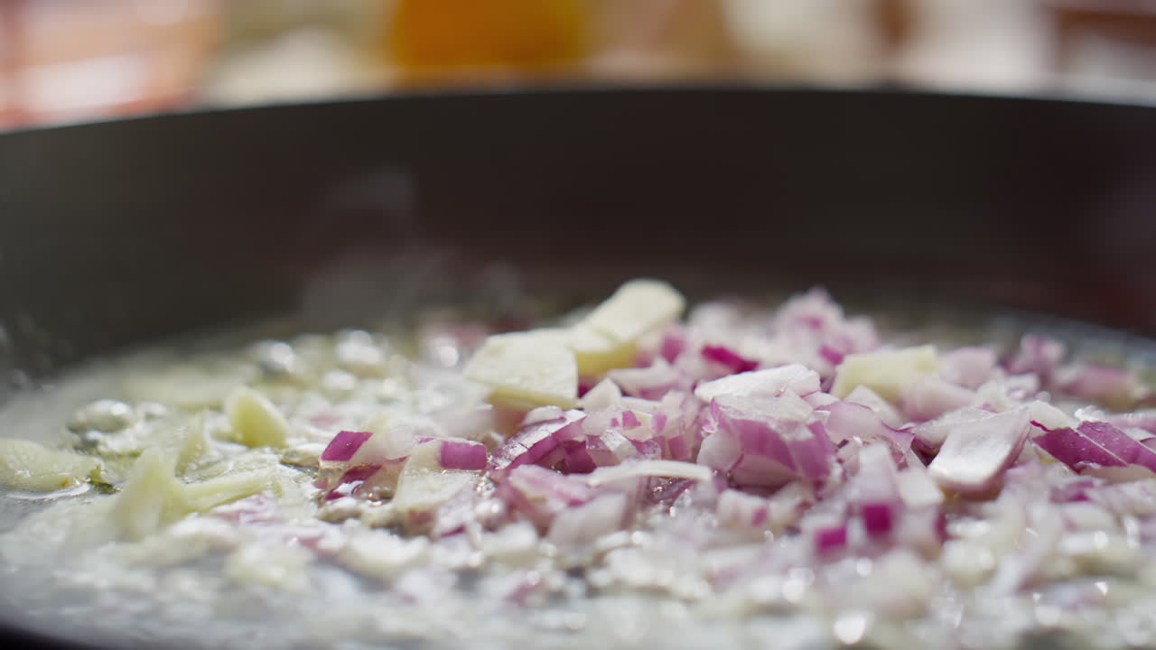 Frying Garlic and Red Onion in Pan