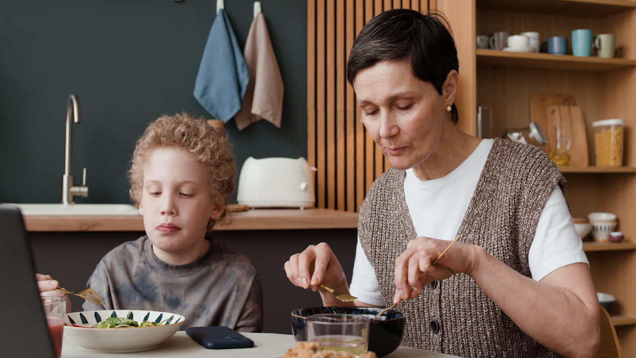 Mother and son share a meal at home