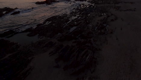 4k reveal aerial shot of a beautiful coastline at sunset