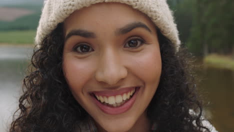 close-up-portrait-beautiful-mixed-race-woman-laughing-looking-happy-wearing-beanie-enjoying-cold-winter-outdoors-in-nature-by-lake-real-people-4k