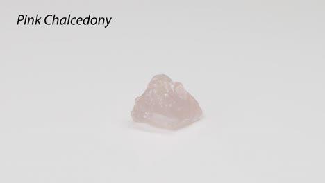 rotating pink chalcedony on a white background