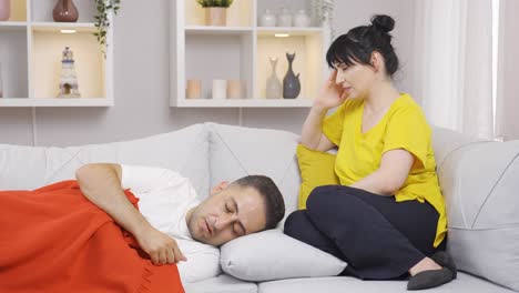 Thoughtful-woman-at-the-bedside-of-her-sick-husband.-Sad.