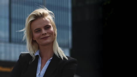 young contemporary businesswoman on the background of office buildings