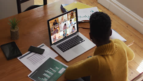 african american female teacher using laptop on video call with students
