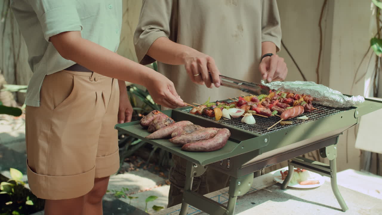 Boyfriend and Girlfriend Cooking Grilled Food Outdoors