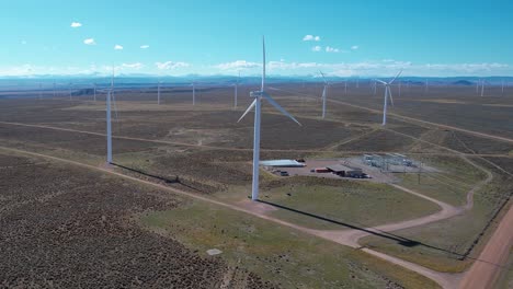 Multiple-windmills-with-spinning-blades-across-a-deserted-landscape