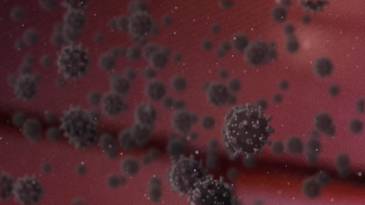 Animazione di cellule Covid-19 che fluttuano su sfondo rosso.