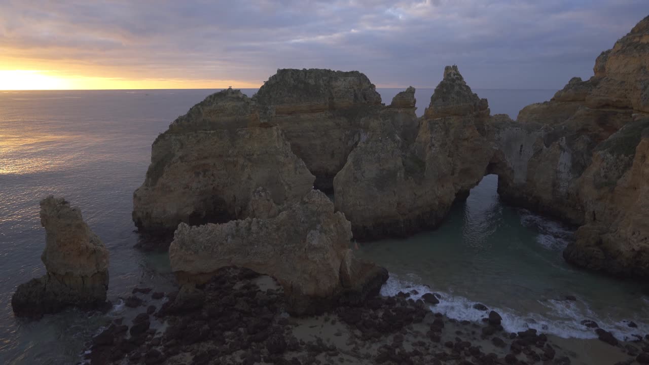 Sunrise over Dramatic Coastal Rock Formations in Algarve, Portugal