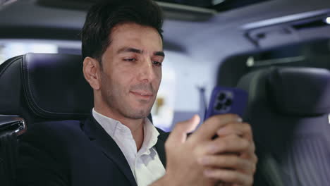 businessman using a smartphone in a car
