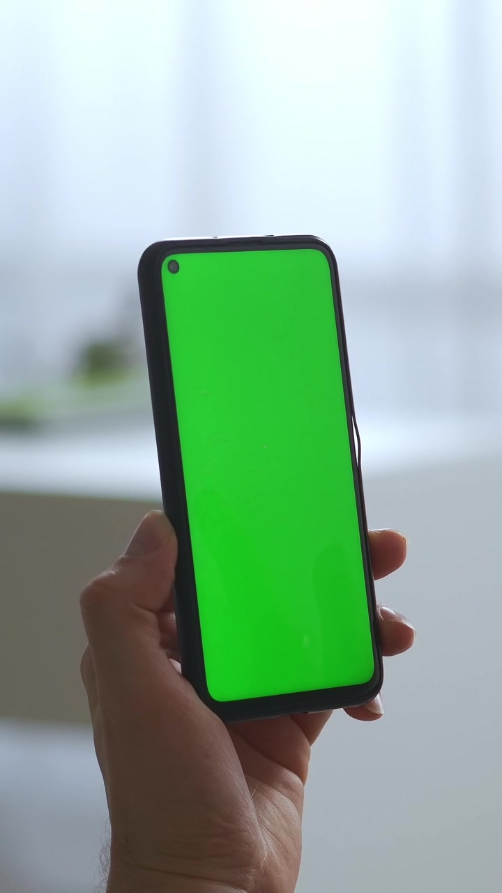Tenere a mano lo smartphone con schermo verde