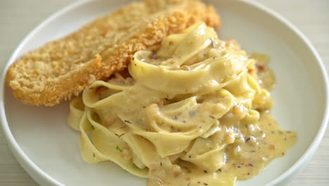 homemade fettuccine pasta white cream sauce with fried fish