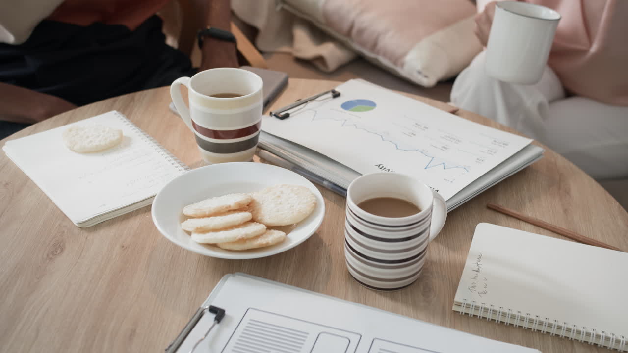 Three Business Managers Drinking Coffee and Eating Snacks during Office Break
