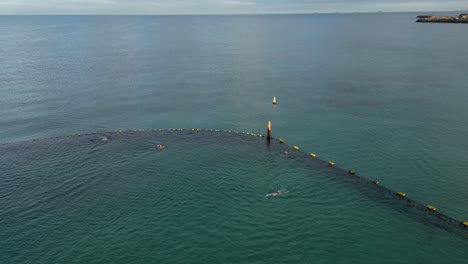 People-swimming-inside-shark-protective-area-at-Coogee-Beach,-Perth-City-in-Western-Australia