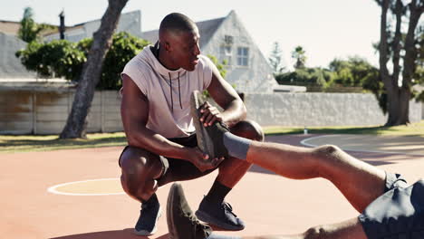 athlete stretching on basketball court