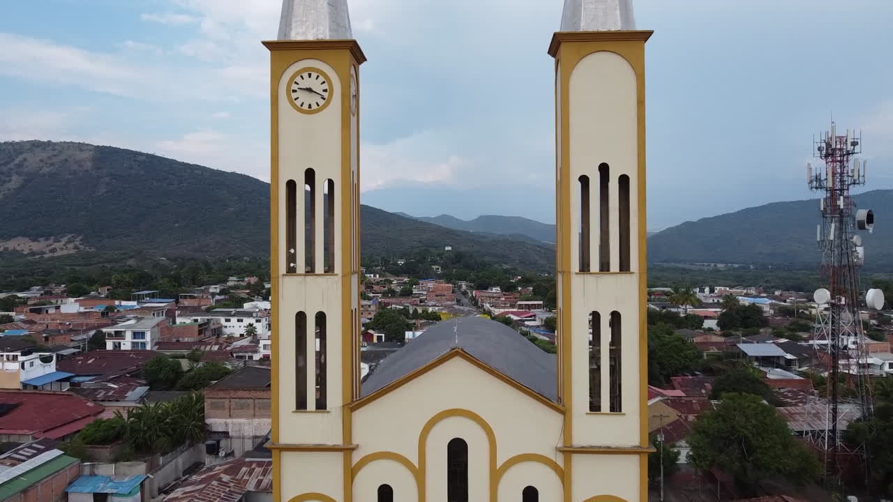 Aerial View of a Town with a Church and Mountains in the Background