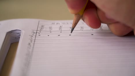 close up of a hand writing with pencil