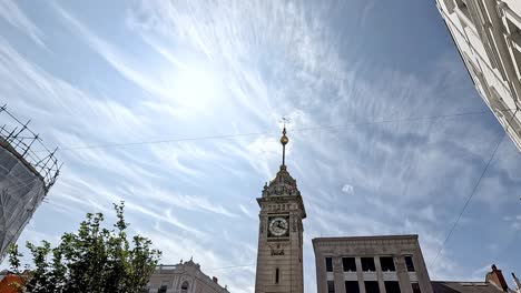 clock tower under a bright, cloudy sky