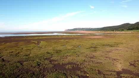 Aerial-view-Traeth-Coch-scenic-Welsh-salt-marsh-moorland-countryside-at-sunset