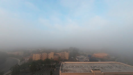 foggy rolling over city at sunrise in california