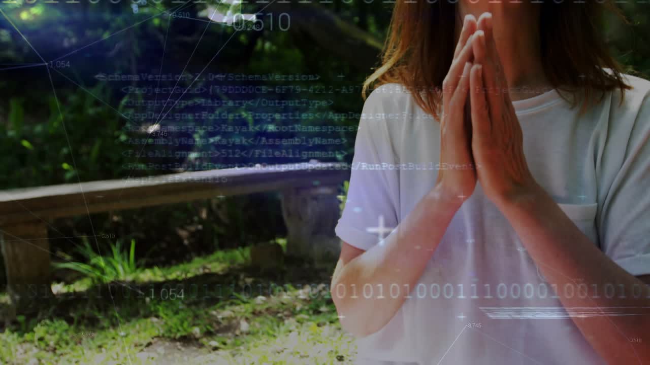 Woman pressing palms and closing eyes in park gesture causing HUD overlays across face for wellness