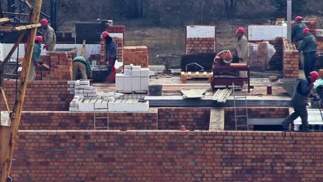 close up of builders with a red helmets on a building under construction. time lapse